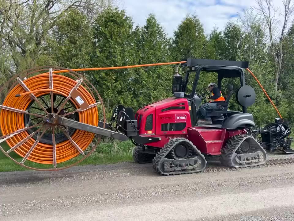 Apex Fibre conduit plow working a rural road shoulder in the Township of Brock